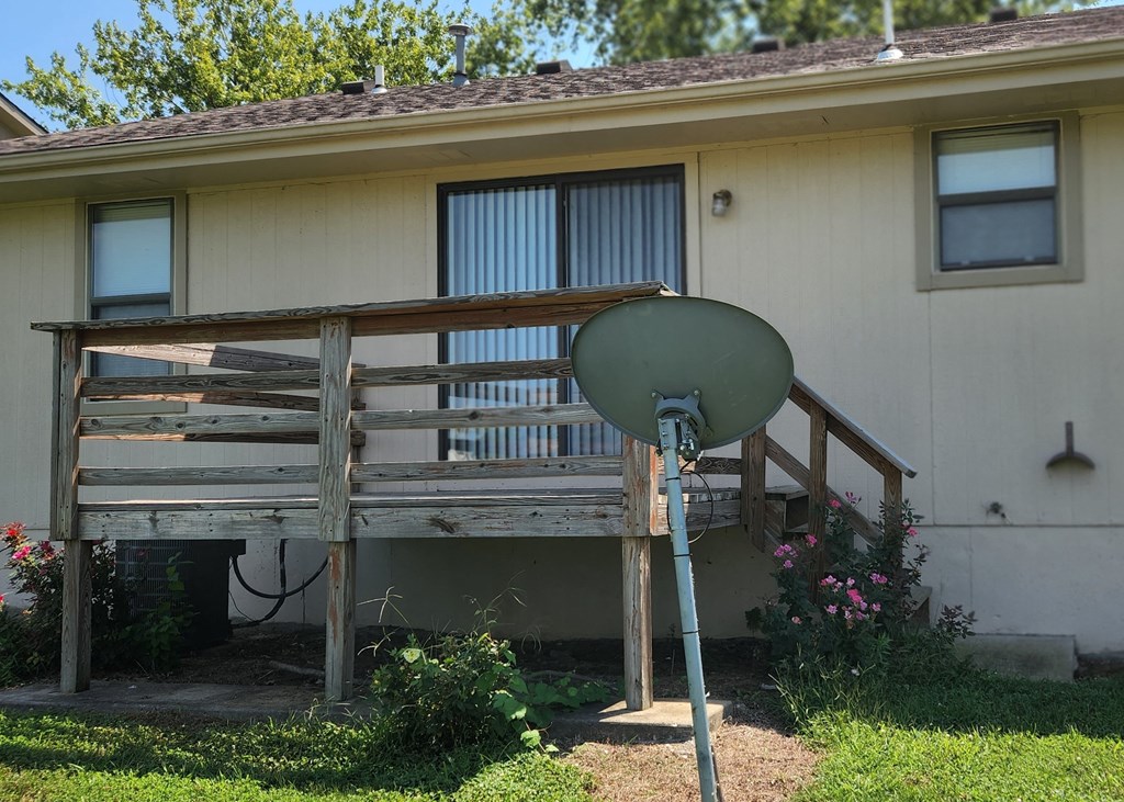 a house with a porch and a satellite dish