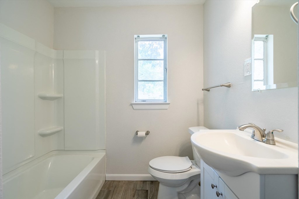 a bathroom with a sink toilet and a bath tub