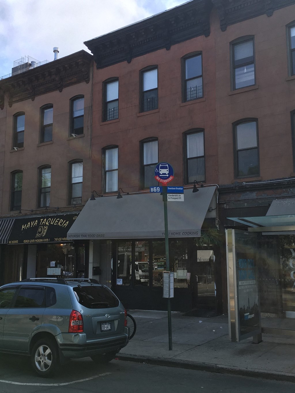 a car parked on the street in front of a building