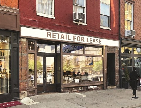 a retail for lease sign on the front of a building