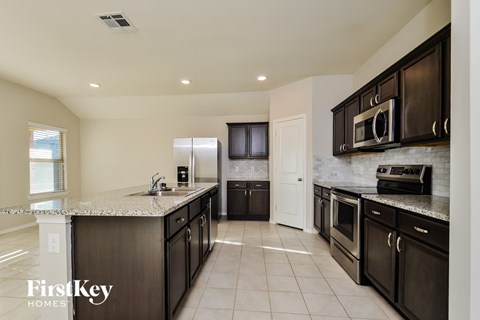 a kitchen with stainless steel appliances and granite counter tops