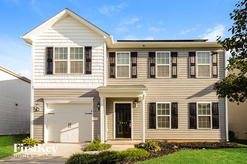 a white house with black shutters and a black front door