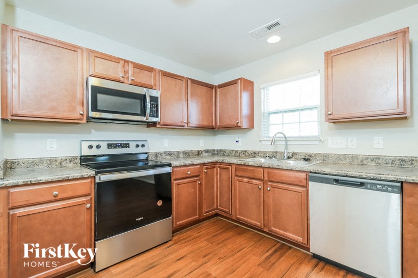 a kitchen with wooden cabinets and stainless steel appliances