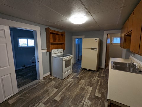 A kitchen with a white fridge, a white dishwasher, and a white oven.