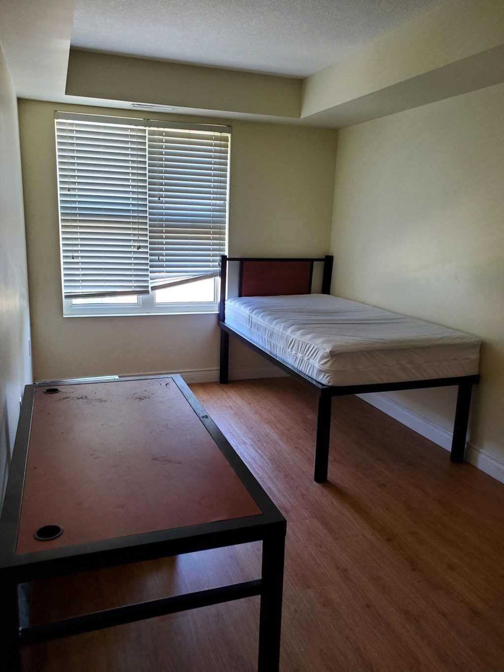 an empty room with a bed and a table