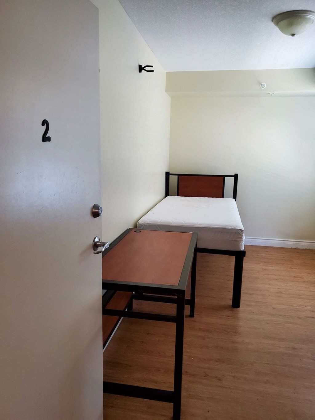 an empty room with a bed and a table