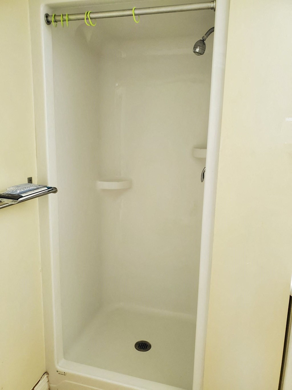 a shower in a bathroom with the door open