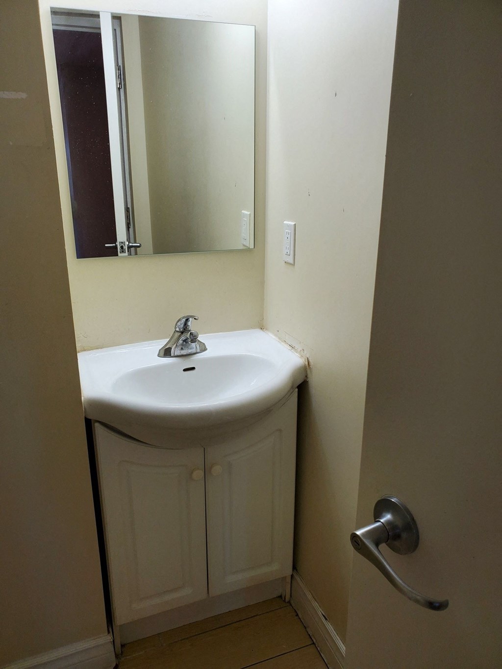 a small bathroom with a sink and a mirror