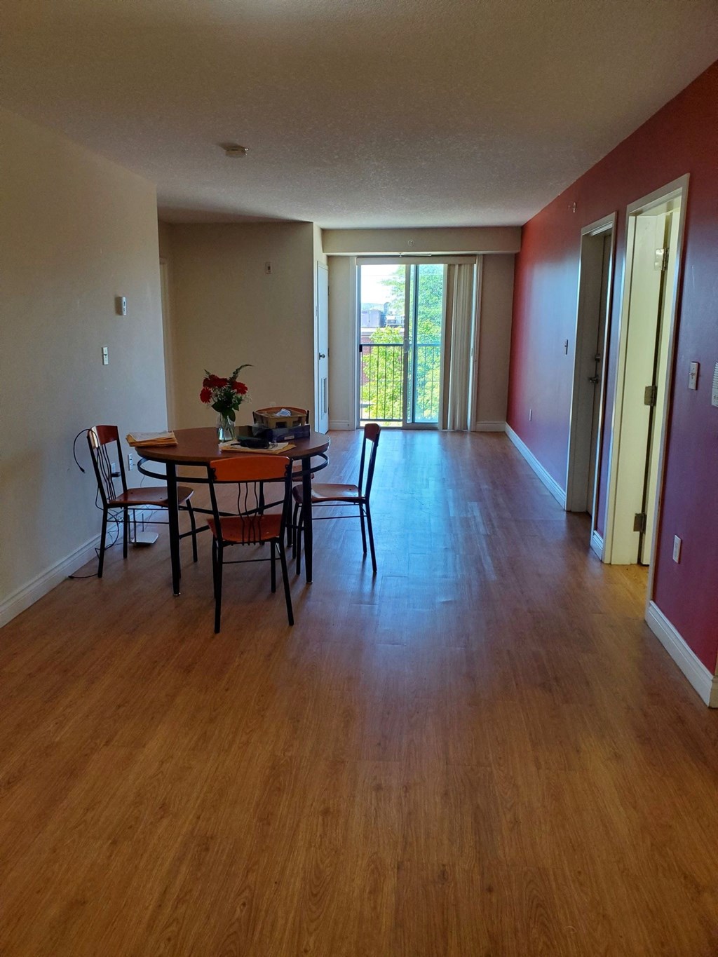 an empty living room and dining room with a wood floor