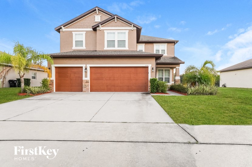 a house with a garage door and a driveway