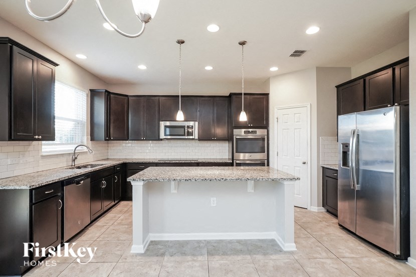 a kitchen with stainless steel appliances and granite counter tops