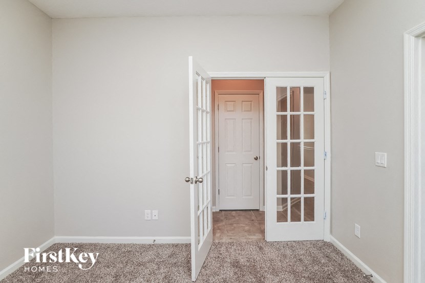 a bedroom with an open door and a closet