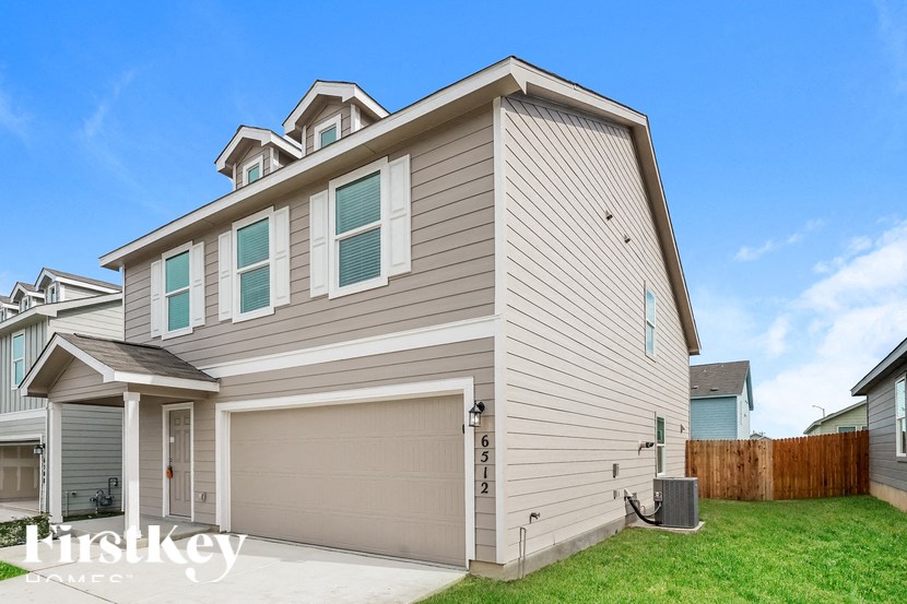 A two-story house with a garage is for sale.