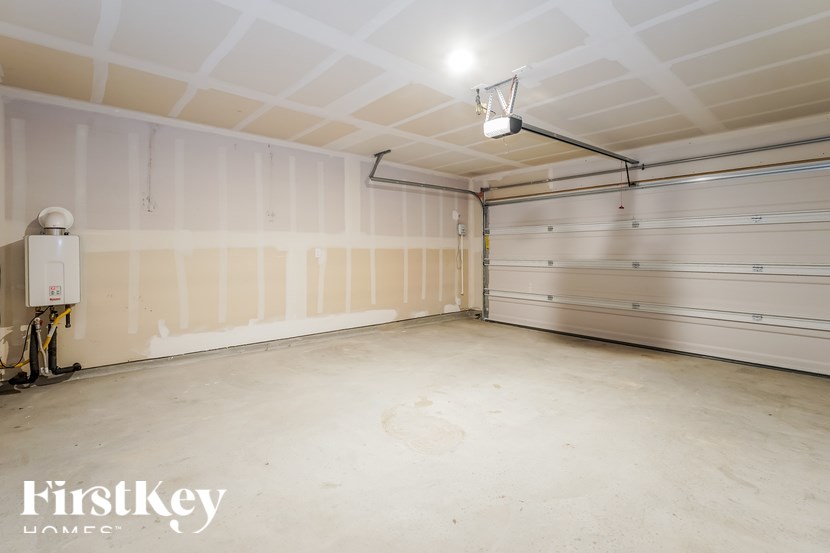 A spacious garage with a FirstKey HOMES sign on the wall.