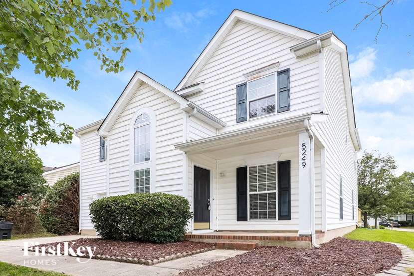 A white house with a black door and windows.