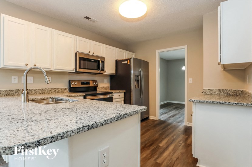 A kitchen with granite countertops and a sink.