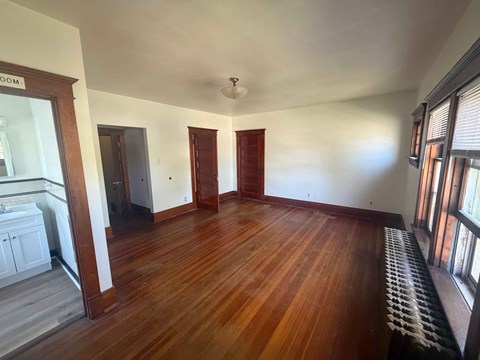 A room with wooden floors and a white ceiling.