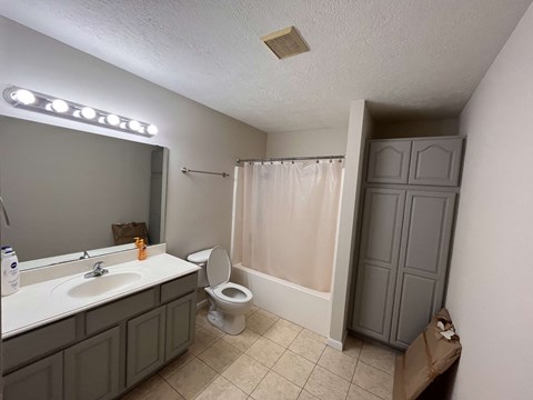 a bathroom with a toilet and a sink and a shower