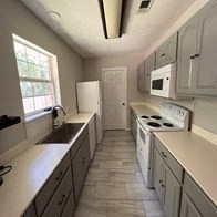 a kitchen with white appliances and white cabinets