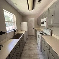 a kitchen with white appliances and white cabinets