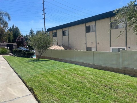 A building with a green lawn in front of it.