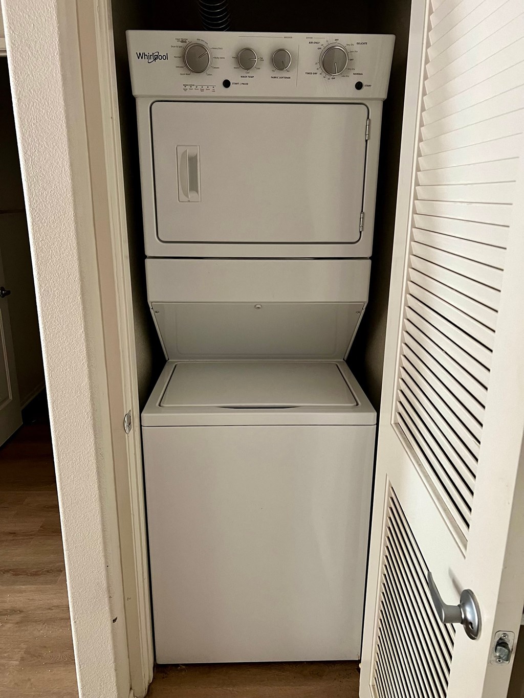 the washer and dryer are in the closet of the room