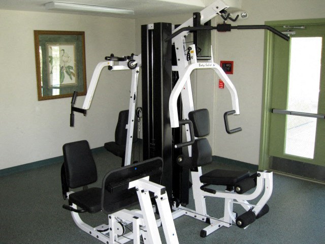 a gym with some exercise equipment in a room