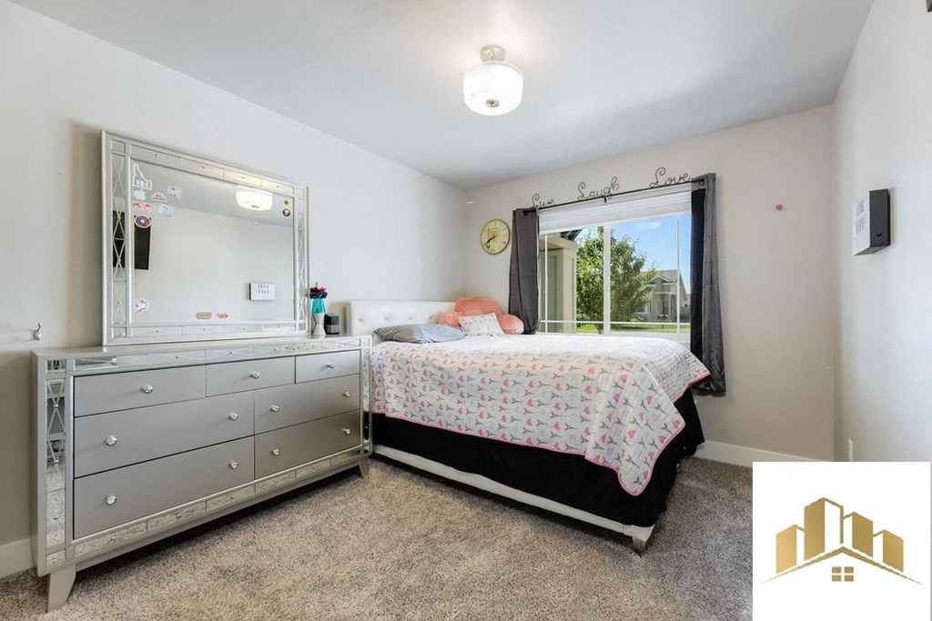 a bedroom with a bed and a dresser and a window