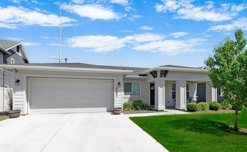 a white house with a driveway and a garage door