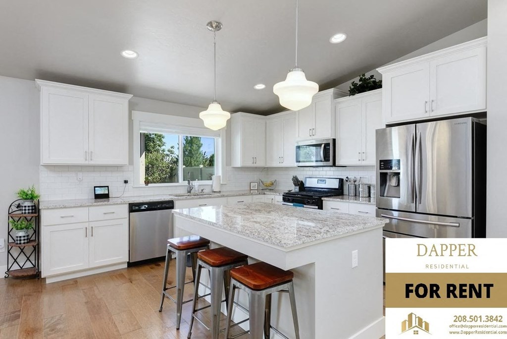 an image of a kitchen with white cabinets and a counter top