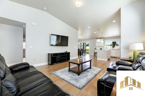 a living room with leather furniture and a tv