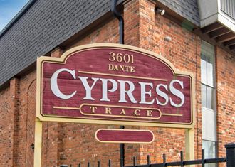 a red brick building with a sign that reads cypress trade