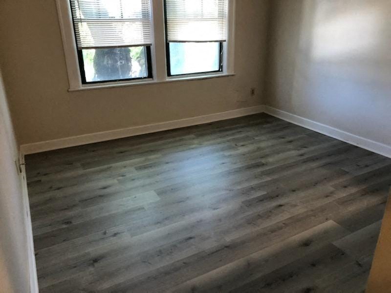 an empty room with wood flooring in a house