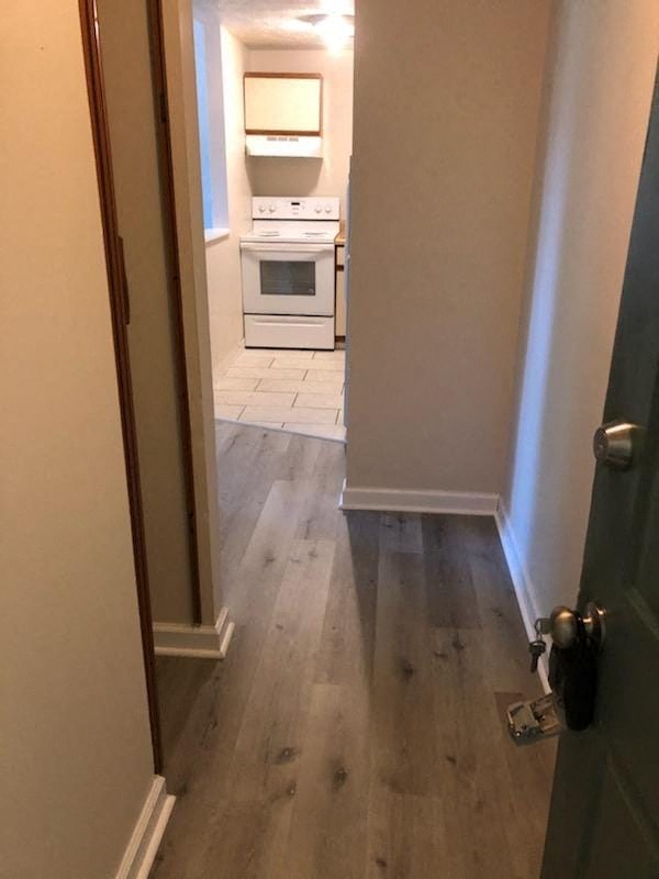 a kitchen with wooden floors and a white stove