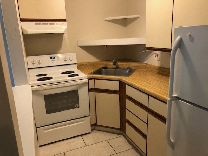 a kitchen with a stove and a sink and a refrigerator