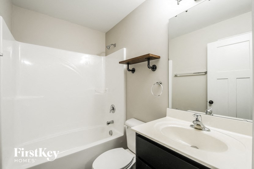 a bathroom with a sink and a toilet and a bath tub