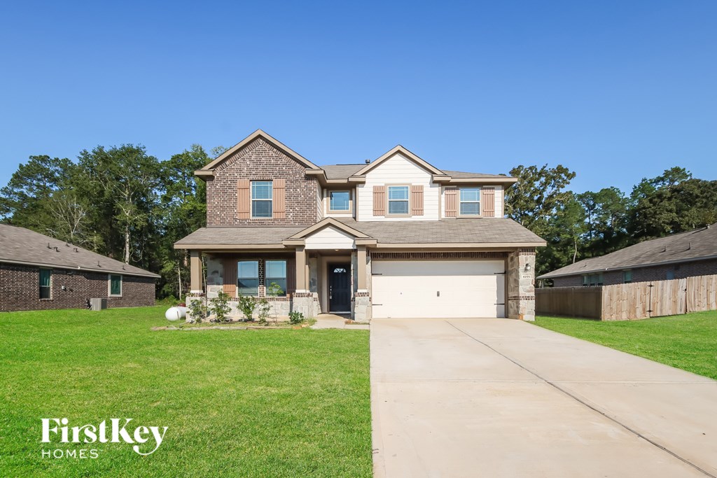 A large house with a driveway in front of it.