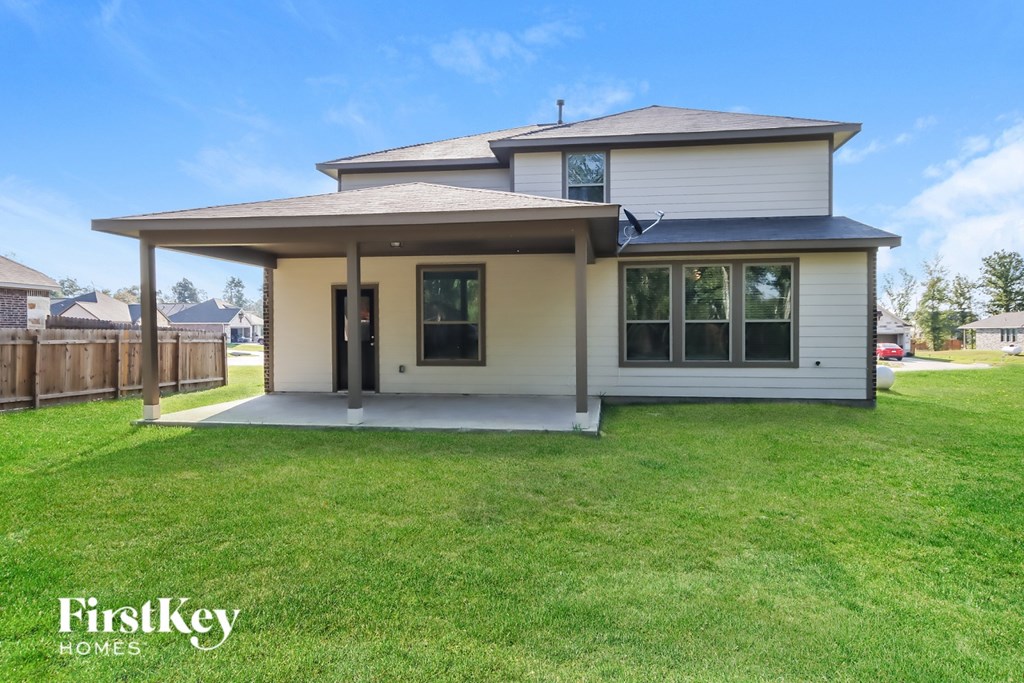 A house with a white front yard and a fence.