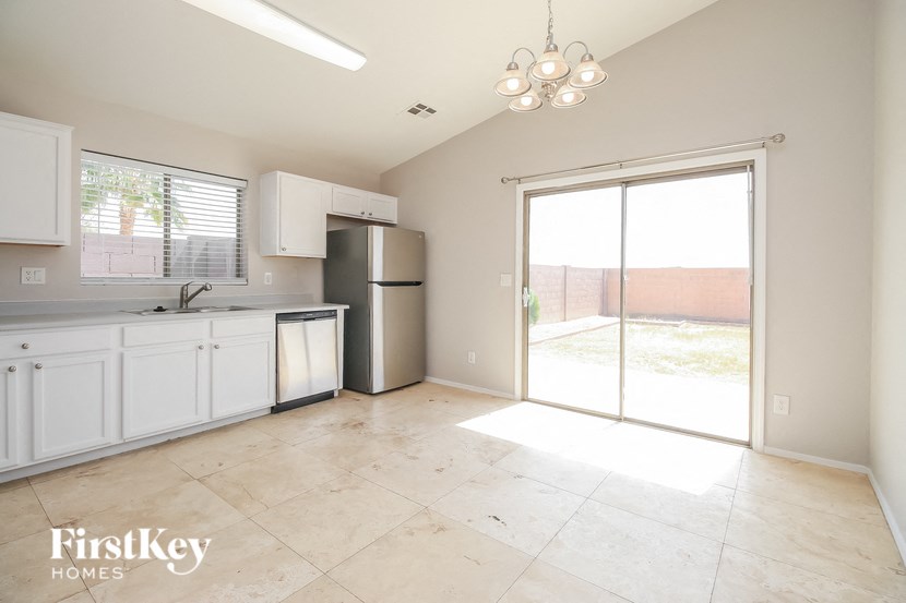 an empty kitchen with a sliding glass door to the patio