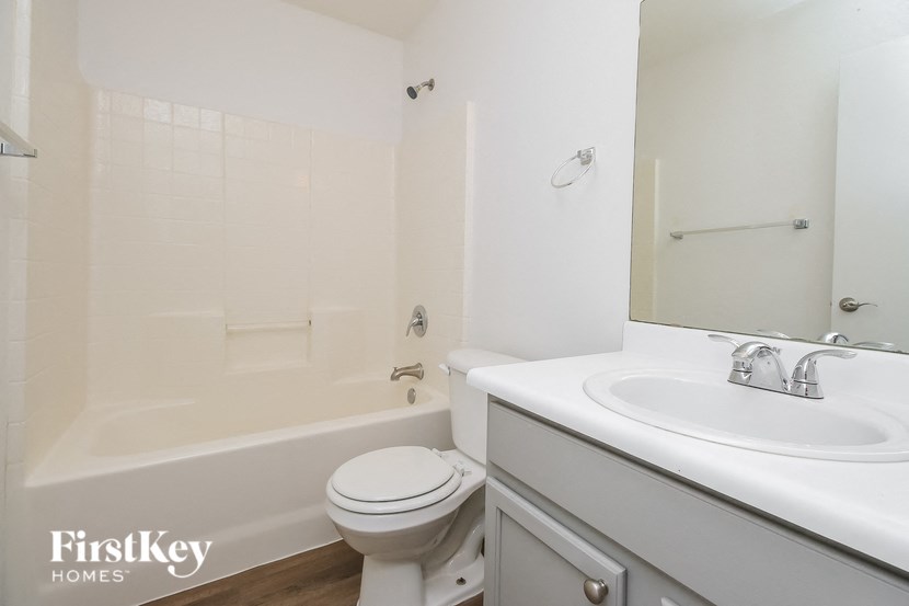 a white bathroom with a sink toilet and tub