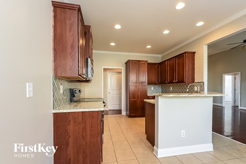A kitchen with brown cabinets and a white island.