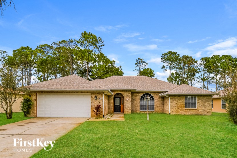 a home with a lawn and a garage