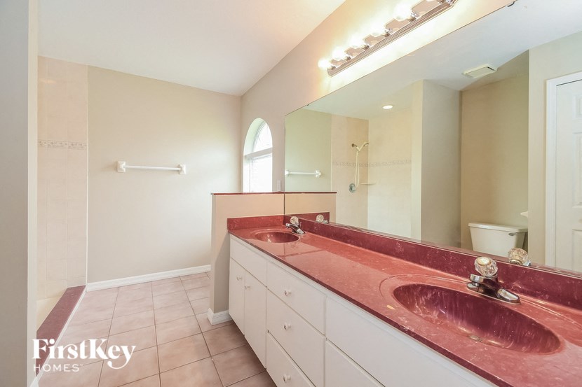 a bathroom with two sinks and a large mirror