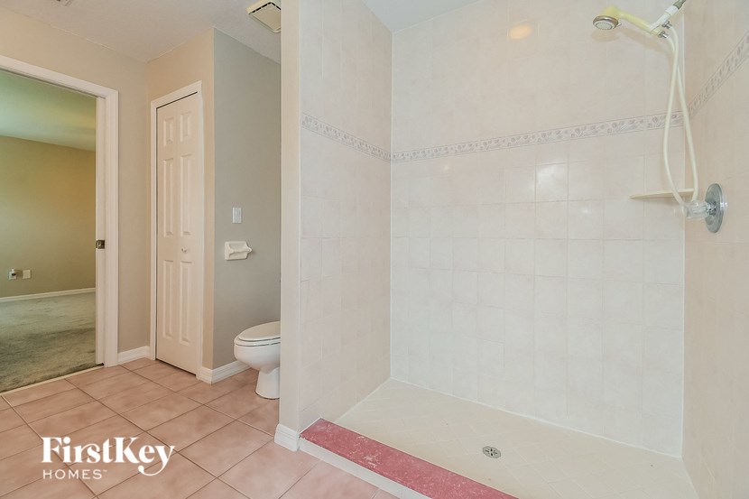 a bathroom with a shower and a toilet in it