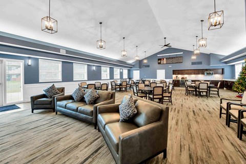 A spacious room with a long couch and chairs.