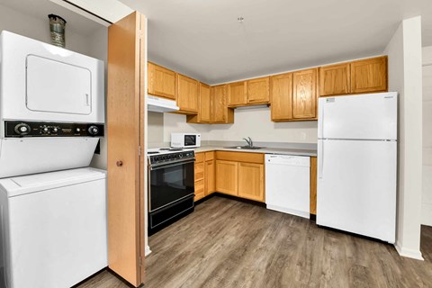 A kitchen with wooden cabinets and white appliances.