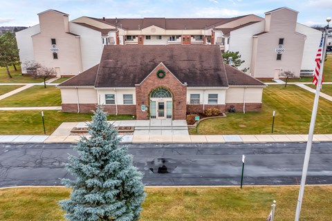 A large building with a green wreath on the front door.