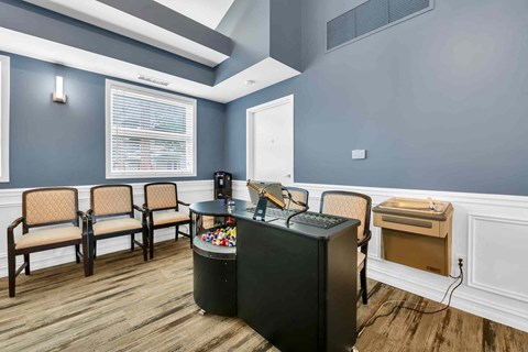 A room with a black table and chairs.