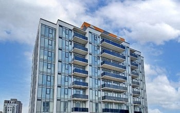 an image of an apartment building with the sky in the background