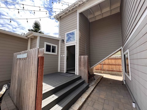 a view of the front door of a house with a porch